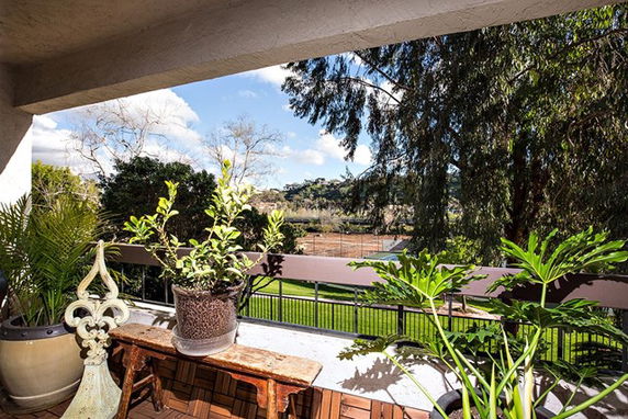 Balcony view overlooking trees and landscape.