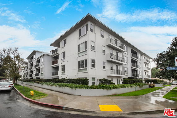 Front view of a multi-story residential building with balconies.