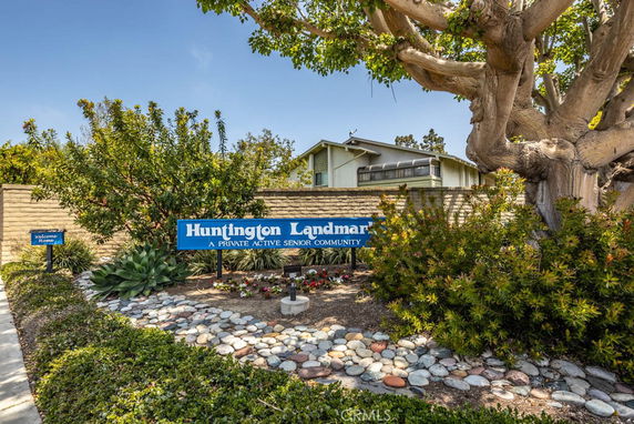 Front view of a community entrance with a sign for Huntington Landmark.
