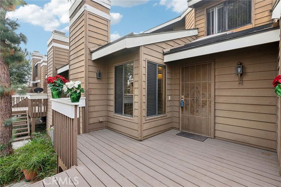 Front view of a multi-story house with a wooden exterior and porch.
