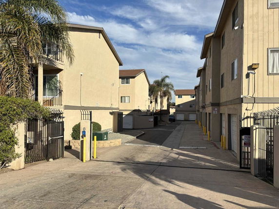 Front view of a multi-story apartment complex with garages.