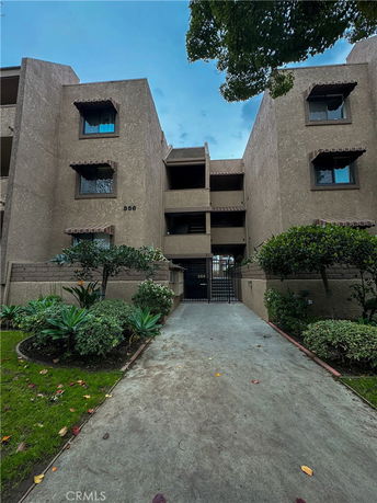 Front view of a multi-story building with gated entrance.