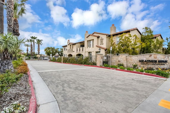 Front view of a luxury condominium complex with a gated entrance.