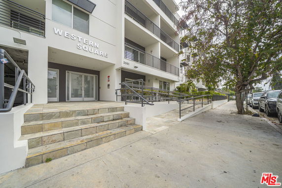 Front view of a multi-story building with balconies and a main entrance labeled 'Western Square'.