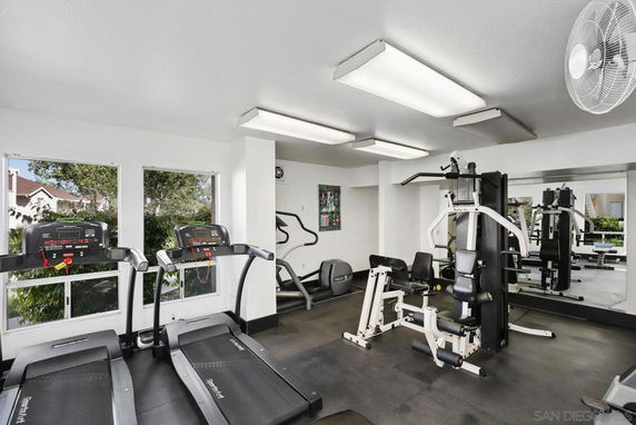 Indoor gym with treadmills and a multi-gym equipment setup.