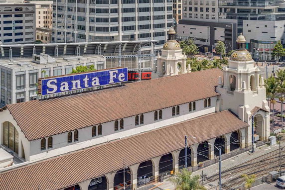 Front view of a large building with arched windows and a sign reading 'Santa Fe'.