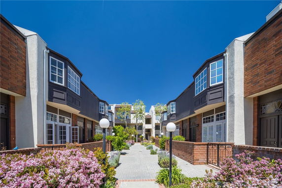 Front view of a townhouse complex with brick and stucco facade.