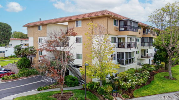 Front view of a multi-story residential building with balconies.
