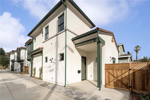 Front view of a two-story house with white exterior and green trim.