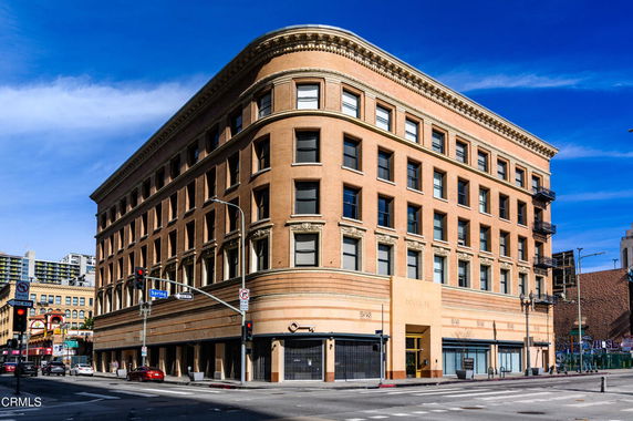 Front view of a multi-story commercial building on a street corner.