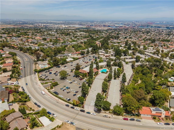 Panoramic view of a residential area with roads, houses, and trees.