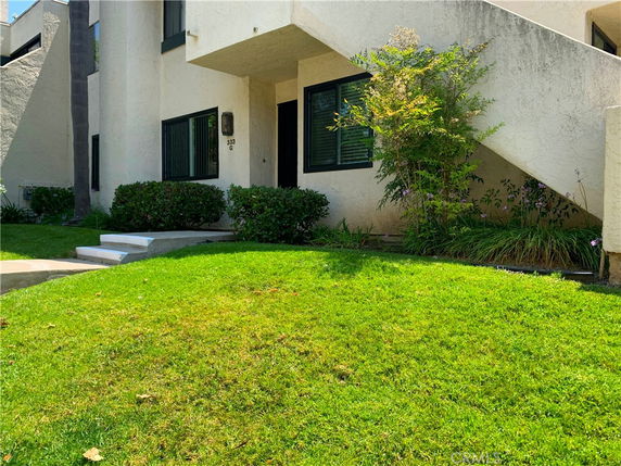 Front view of a modern multi-story house with a staircase.