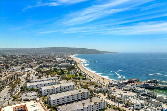 Panoramic view of a coastal city with a beach and ocean.