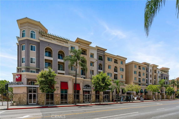 Front view of a multi-story residential and commercial building.
