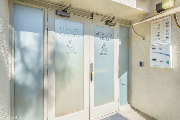 Entrance to a fitness center with frosted glass doors.