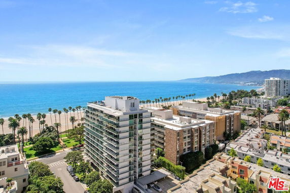 Panoramic view of a coastal area with high-rise buildings and the ocean in the background.