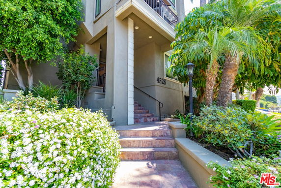 Front view of a multi-story building entrance with a staircase.