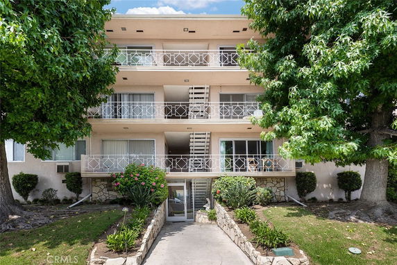 Front view of a multi-story residential building with balconies.