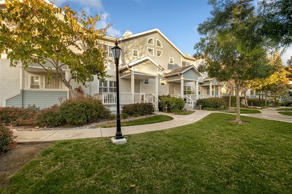 Front view of a multi-story townhouse complex with porches.