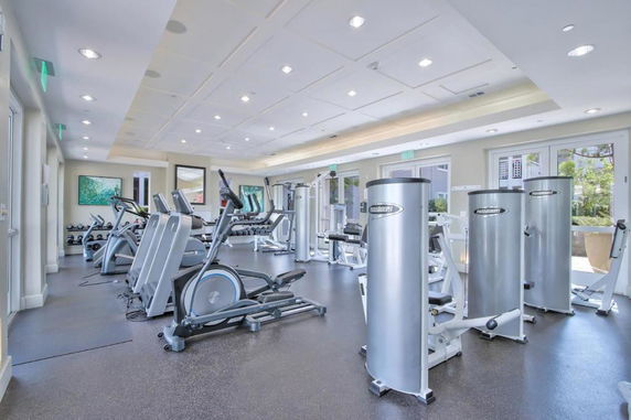 Interior view of a well-equipped gym with exercise machines and equipment.