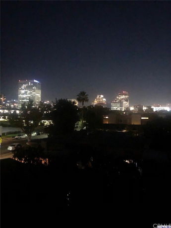 Nighttime cityscape view with buildings and lights.
