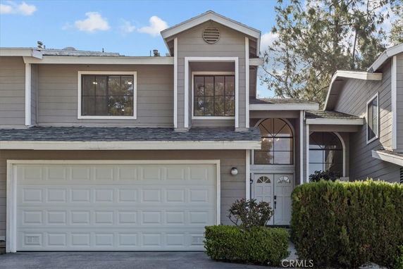 Front view of a two-story house with a garage.