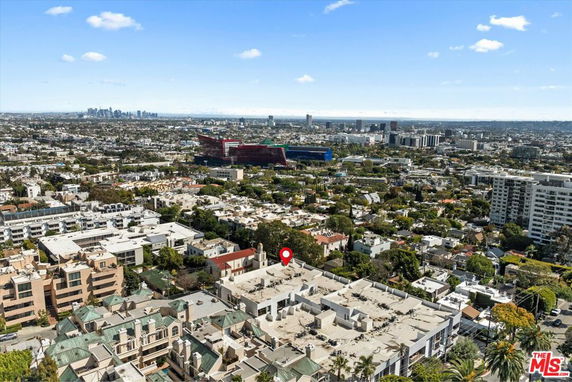 Wide-angle view of a cityscape with multiple buildings and a distant skyline.
