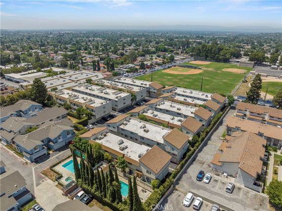 Panoramic view of residential buildings with flat rooftops in a suburban area.
