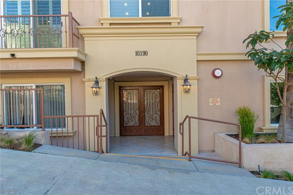 Front view of a building entrance with double doors and decorative lighting.