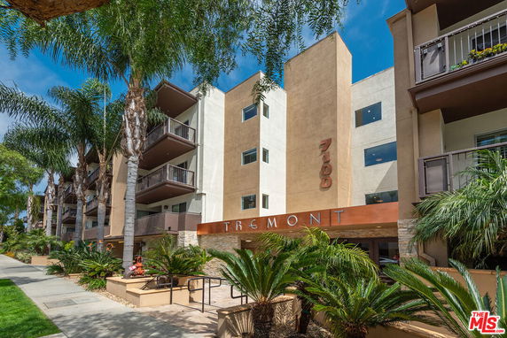 Front view of a multi-story residential building with balconies.