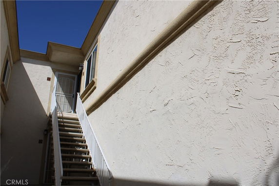 External staircase leading to the entrance of a multi-story building.