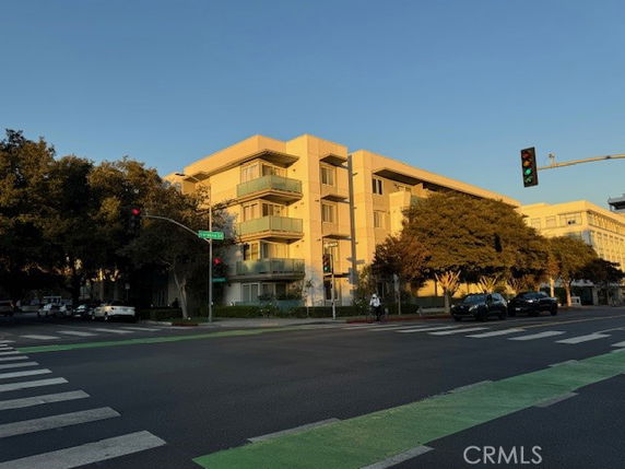 Front view of a multi-story apartment building at an intersection.