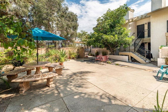 Outdoor area with a patio and building entrance.