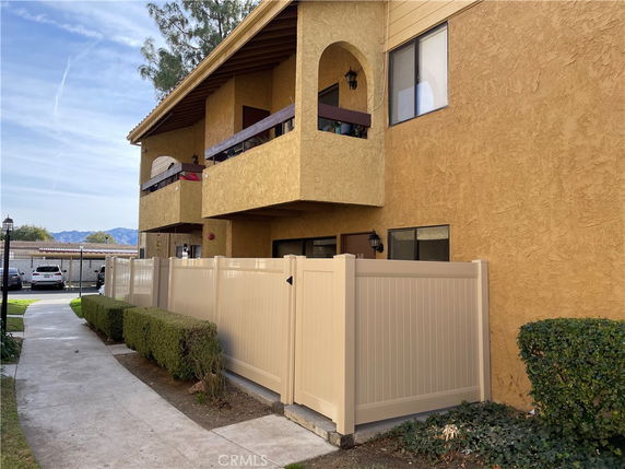 Front view of a multi-story apartment building with balconies.