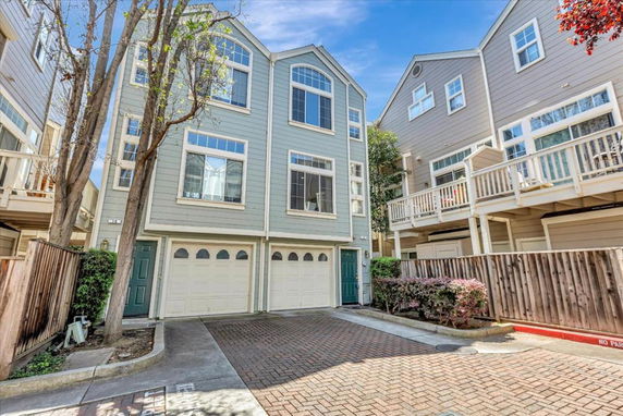 Front view of a multi-story townhouse with a garage and entrance.