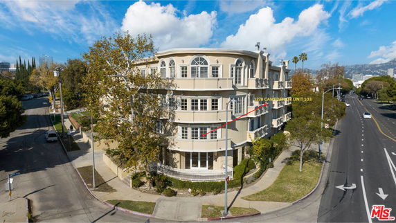 Front view of a multi-story residential building with balconies.