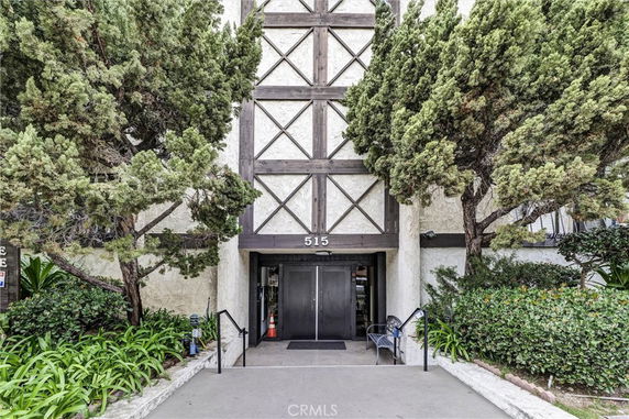 Front view of a building entrance with decorative wood paneling.