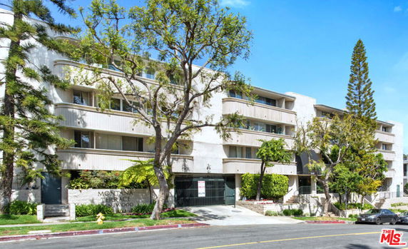 Front view of a multi-story residential building with balconies.