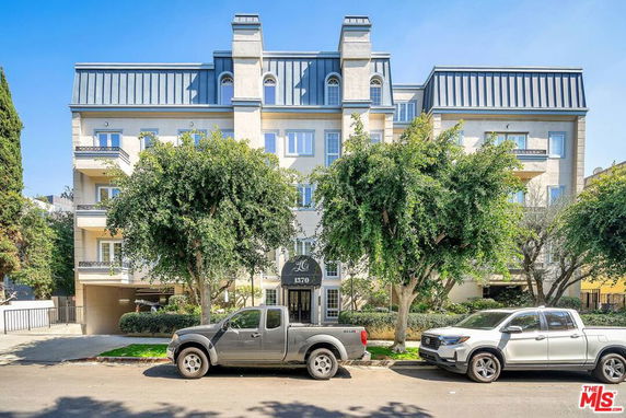 Front view of a multi-story residential building with balconies.