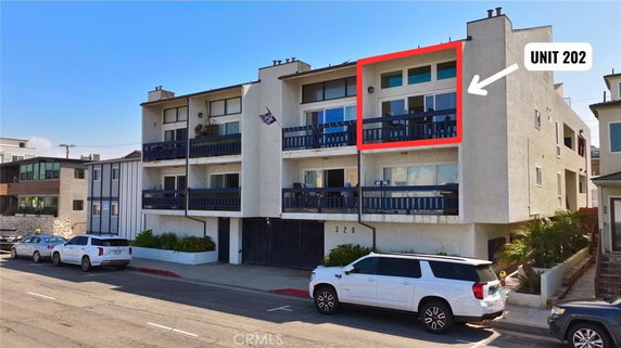 Front view of a multi-story apartment building with balconies.