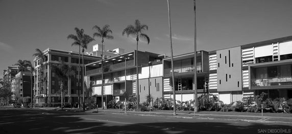 Front view of a multi-story residential building complex with modern architectural design.