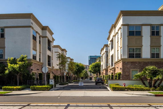 Front view of multistory residential buildings with gated entrance