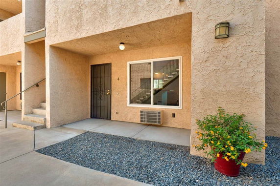 Front view of an apartment entrance with a metal door and window.