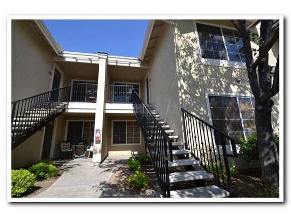 Front view of a building with two staircases leading to the upper level.