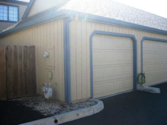 Side view of a house with a double garage.