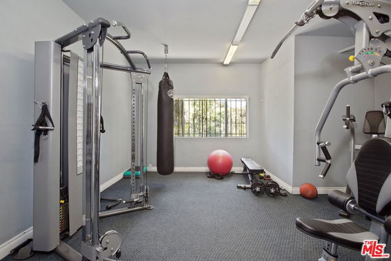 Indoor gym area with exercise equipment and a punching bag.