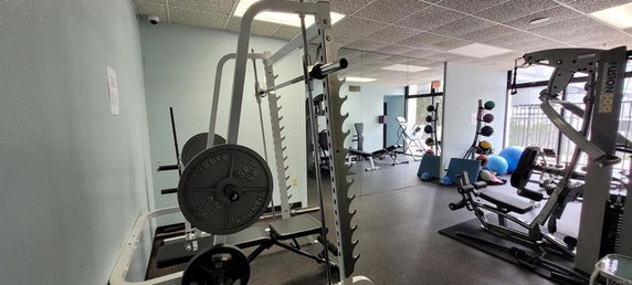 Indoor gym area with various fitness equipment.