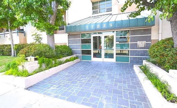 Front view of a building entrance with glass doors.