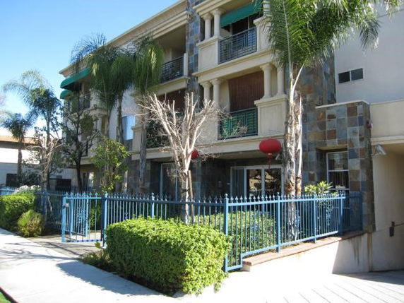 Front view of a multi-story residential building with balconies.