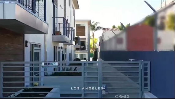 Front view of a modern multi-story building with balconies.